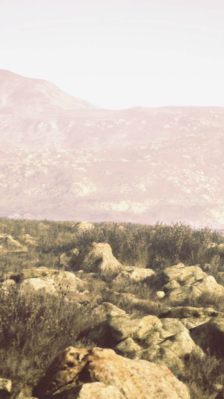 Landscape showing rocky terrain and distant mountains during golden hour