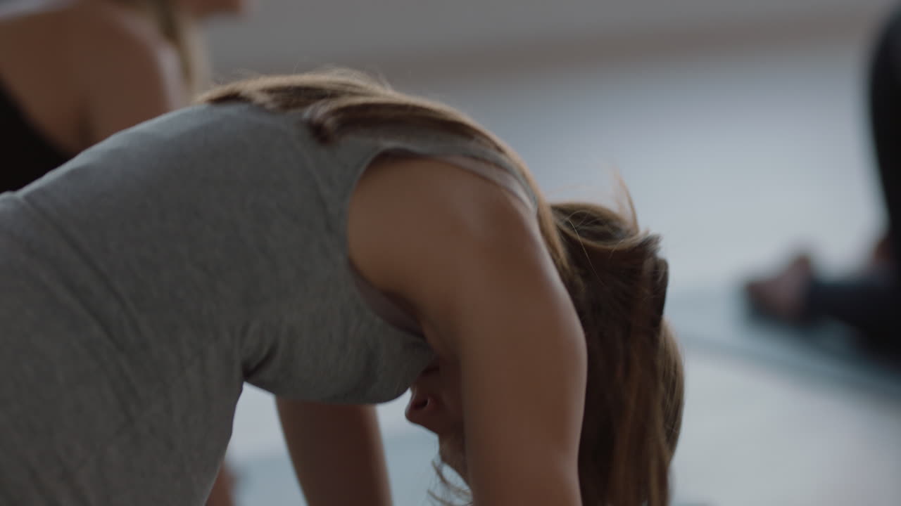 clase de yoga mujer caucásica embarazada ejerciendo un estilo de vida saludable practicando pose de vaca gato disfrutando de un entrenamiento físico en grupo en el estudio al amanecer