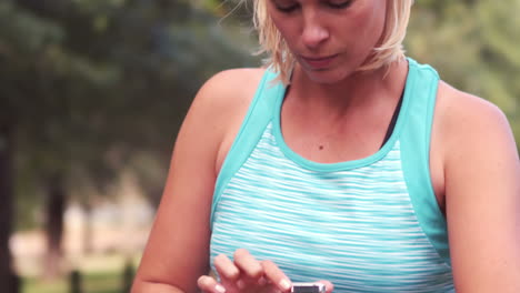 fit woman setting heart rate watch