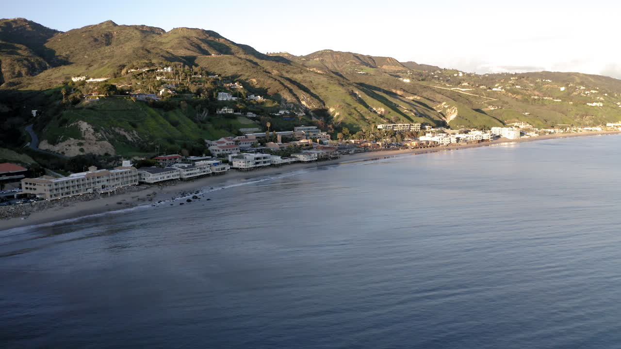 Aerial View of Malibu Coastline with Pier, Beach, and Mountains