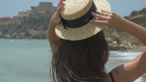 woman in a straw hat on a beach