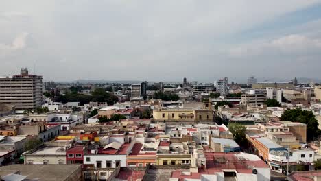 a rising aerial drone shot from the midtown of guadalajara in mexico