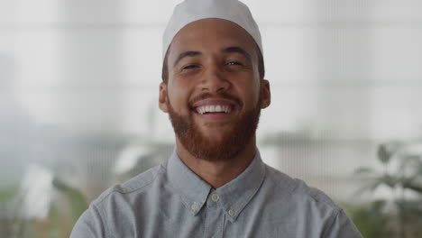 portrait young successful muslim businessman laughing enjoying professional career success mixed race entrepreneur wearing kufi hat in office slow motion