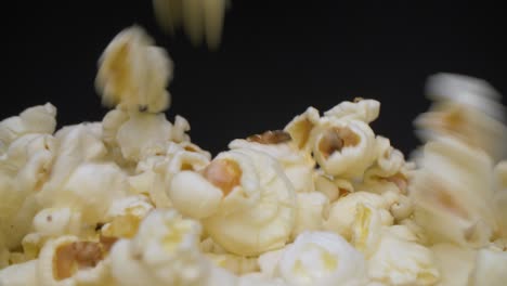 close-up view of buttered popcorns falling into the bowl