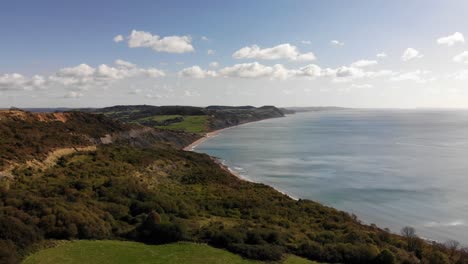 aerial shot of the jurassic coast from lyme regis looking towards charmouth on a beautiful summers day