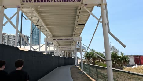 people walking and cycling along a covered pathway