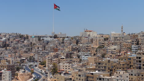 panorama of the city of amman, jordan with flag view from jabal al qal'a, the citadel of amman. zoom. 4k