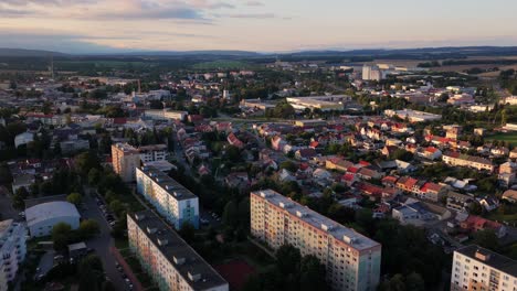 aerial drone view of the town of svitavy during a calm evening. residential apartment blocks are nestled in a peaceful neighborhood, with soft evening light casting long shadows over the quiet streets