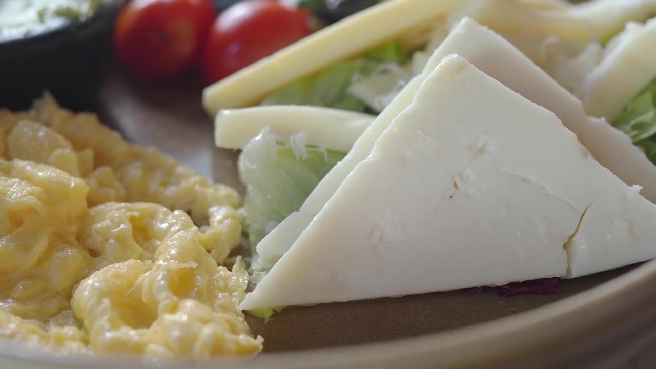 Primo piano di un piatto di colazione sana con uova strapazzate e formaggio