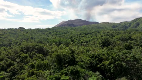 Toma-Aérea-De-Drones-Del-Paisaje-Del-Volcán-Monte-Yasur-En-El-Fondo-Con-Humo-Sobre-La-Isla-De-Tanna-Selva-Tropical-Islas-Del-Pacífico-Vanuatu-4k