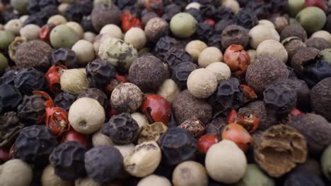 macro close-up mixed peppercorns. dry mix peppercorns close up