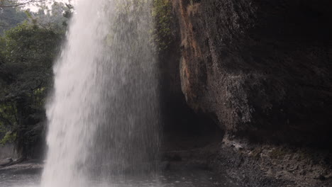 4K-close-up-clip-of-a-waterfall-seen-from-a-side-splashing-water-in-the-middle-of-a-lush-lost-jungle-taken-on-a-trip-to-southeast-Asia-national-parks