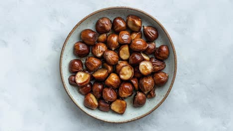 Bowl-of-Roasted-Chestnuts-on-Rustic-Plate-Background