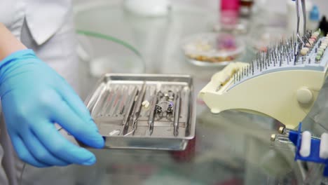 dentist picking up the instruments from the instrument table. healthy teeth