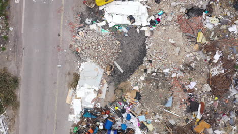 heaps of garbage pile of rubbish illegal dumping on a road aerial top down view