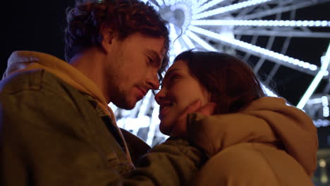 Smiling-couple-looking-eyes-to-eyes-on-urban-street.-Man-touching-woman-face.