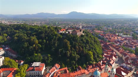 stunning drone footage of ljubljana, slovenia, showcasing the charming old town, the medieval castle, and the vibrant city center with its picturesque streets and unique architecture.
