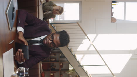 African-American-Businessman-Using-Digital-Tablet-in-Restaurant