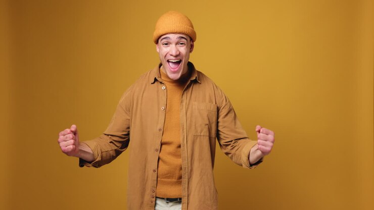 Cheerful Man Posing in Front of Yellow Background