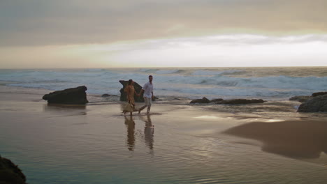 Unknown-spouses-walking-sea-beach.-Love-pair-enjoying-date-vertical-oriented.