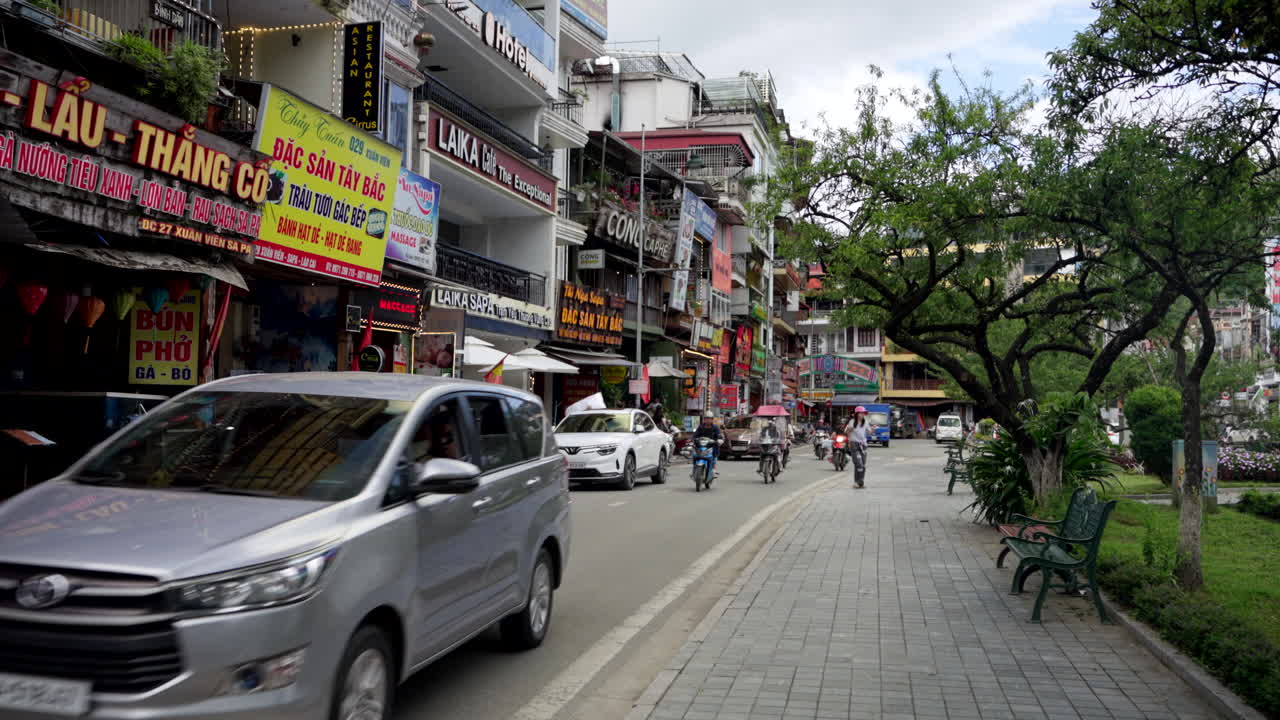 Business facades, traffic travel, residents motorbike lifestyle commute