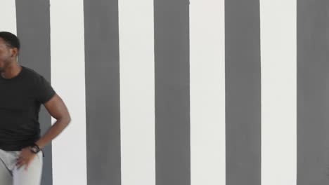 Man Dancing in Front of Striped Wall