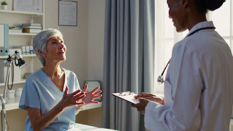 doctor consults with a senior patient in a clinic