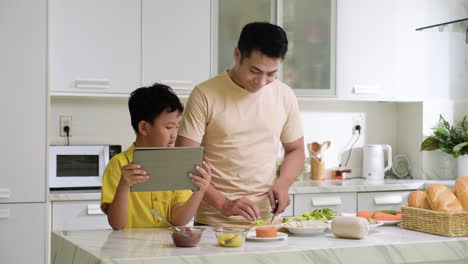 asian man and boy in the kitchen