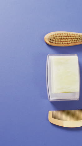 vertical video of brush, cone and soap on blue background with copy space