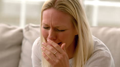 in slow motion woman crying sitting on sofa