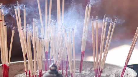 burning incense sticks at a temple