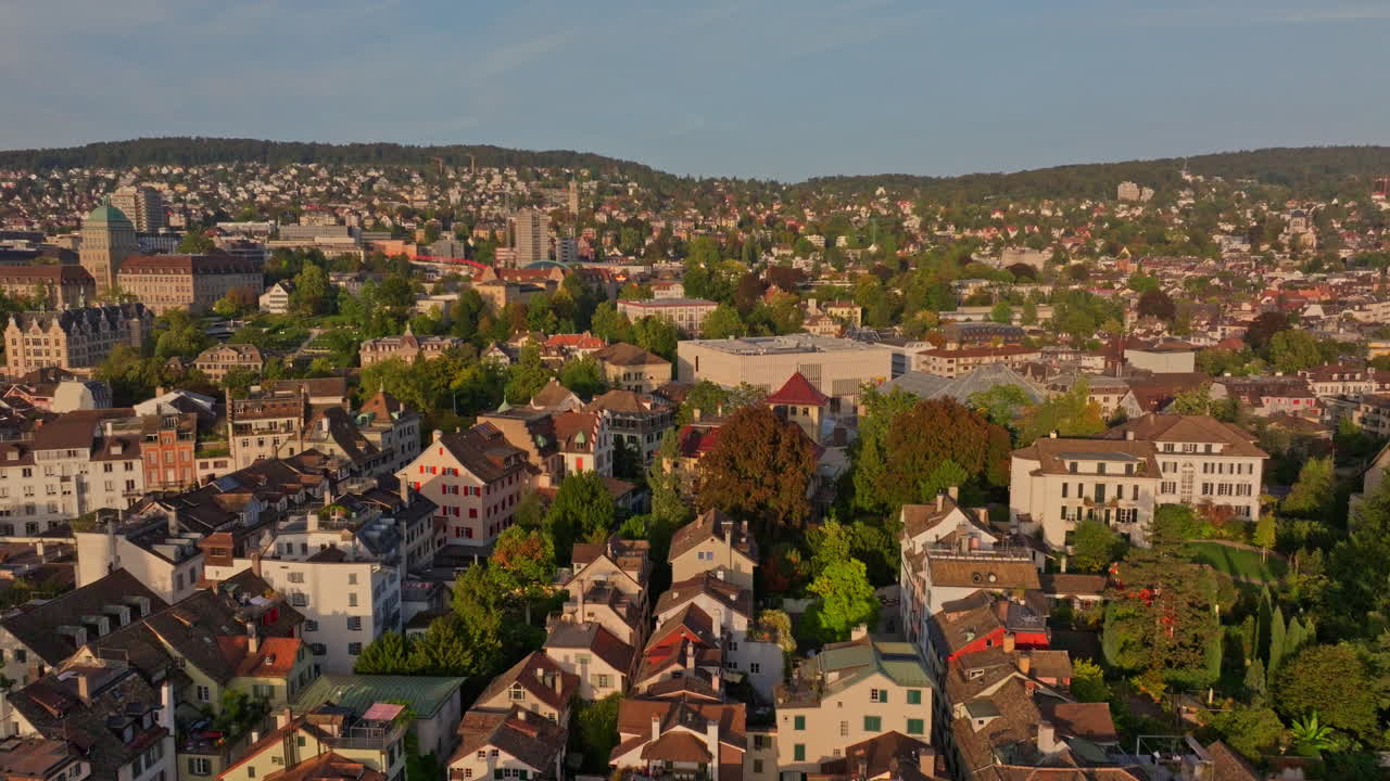 Golden summer sunset over Zürich, captured by drone with stunning views of the city, lake, river, and iconic churches.