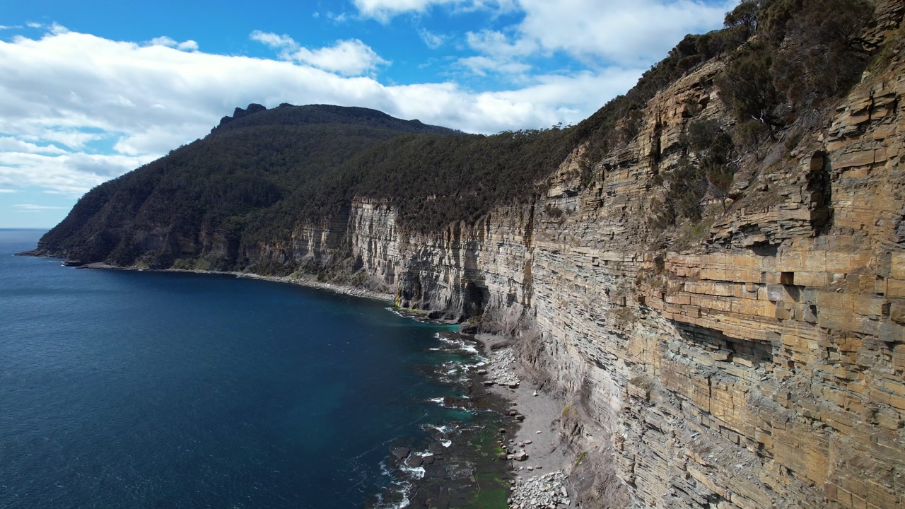 Fossil Bay Cliffs Over Turquoise Ocean, Tasmania, Australia - drone shot