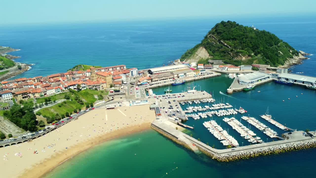 Aerial view of a coastal town with beach and harbor