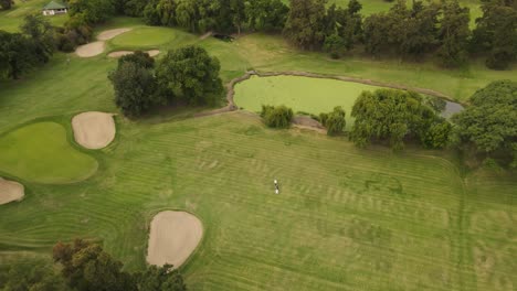 orbit aerial shot of golfer and caddie in buenos aires golf club