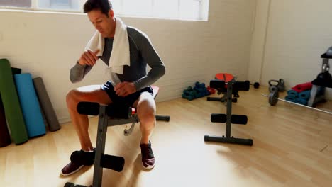 tired man relaxing on gym bench 4k