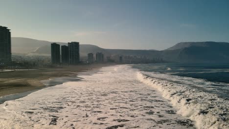 sea waves crashing on city seashore