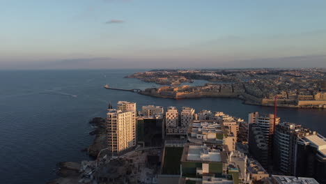 sun rise drone footage of valletta harbor in the morning, malta