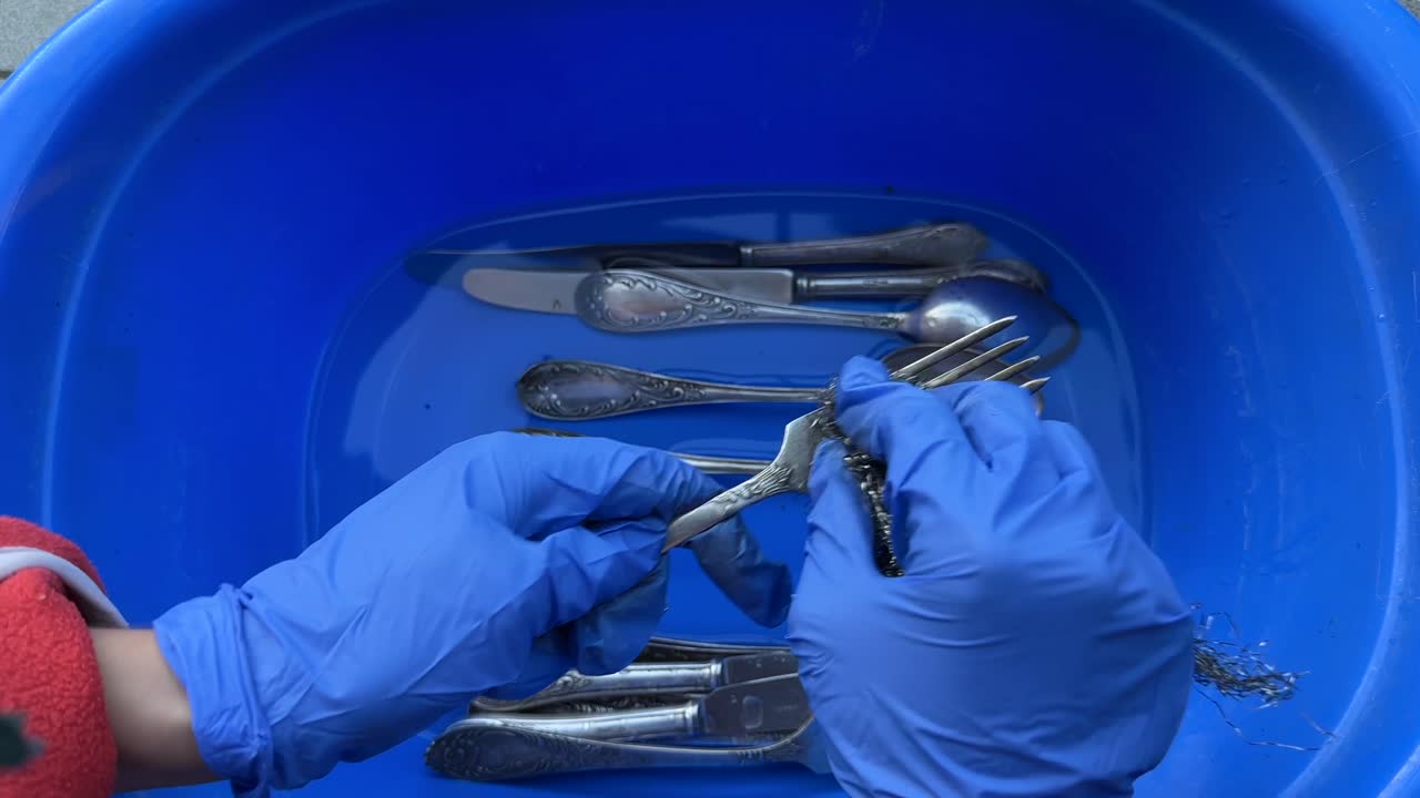 Washing Vintage Cutlery in a Blue Bowl