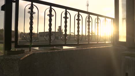 sunrise through a park fence