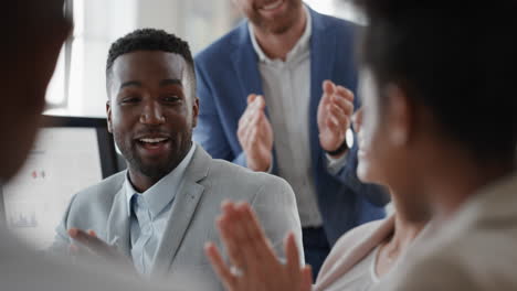 african american businessman celebrating with colleagues high five in office meeting having fun celebration sharing teamwork victory in workplace