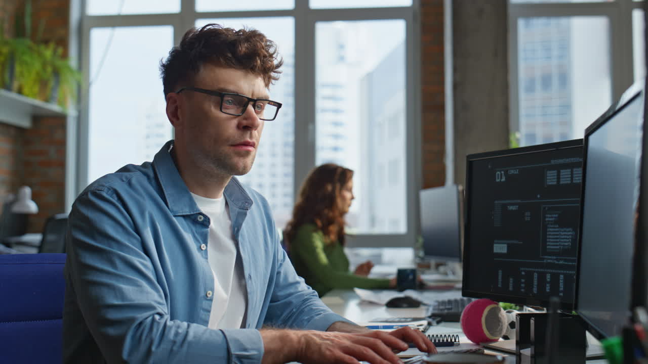 Focused man looking desktop at open space closeup. Freelancer working computer