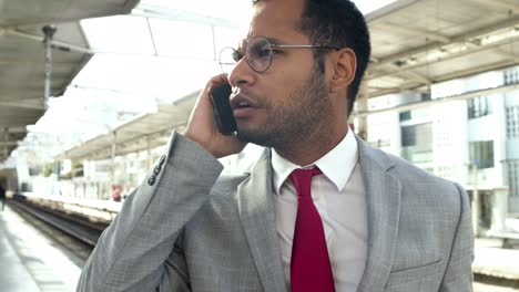 serious businessman talking by cell phone