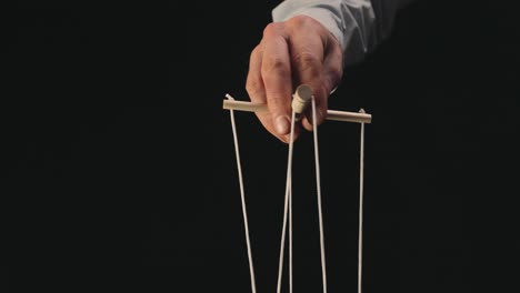 Hand manipulating marionette strings