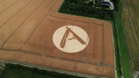 Aerial-view-looking-down-over-Hackpen-hill,-Swindon-2023-cut-throat-razor-crop-circle-design-on-agricultural-farmland