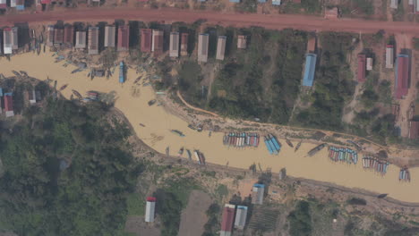 aerial following boat along the tonle sap in village on stilts in cambodia