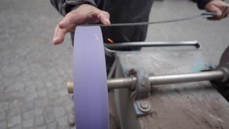 street vendor sharpening a knife