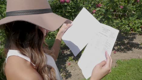 young woman reads information about the apple harvest