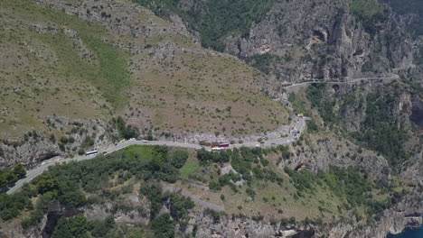 Aerial-orbits-vehicle-traffic-on-cliff-side-Amalfi