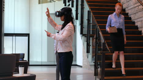 businesswoman using virtual reality headset in office 4k